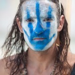 burning-man-2013-cargo-cult-black-rock-city-playa-jonathan-clark-man-wth-blue-painted-hand-on-face