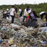 686193-environmental-advocates-pick-up-trash-along-a-coastline-to-mark-international-coastal-cleanup-day-in