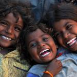 3 children&rsquo;s faces laughing