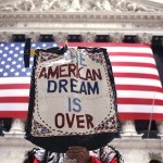 A demonstrator holds a sign during a rally outside Wall Street in New York