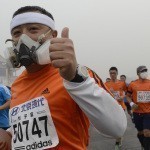 Participants wearing masks during a hazy day at the Beijing International Marathon in front of Tiananmen Square, in Beijing