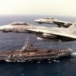Grumman_F-14A_Tomcats_of_VF-14_fly_over_French_aircraft_carrier_Foch_(R99)_in_the_Caribbean_Sea,_1_May_1990_(6451896)