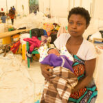 RS41991_A mother and his baby at makombe transit site_scr